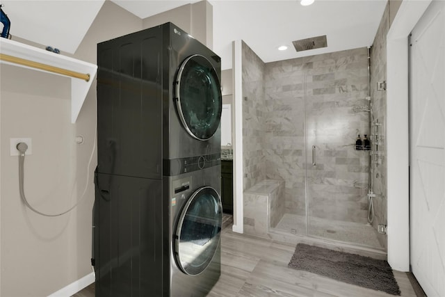 washroom featuring stacked washer / drying machine