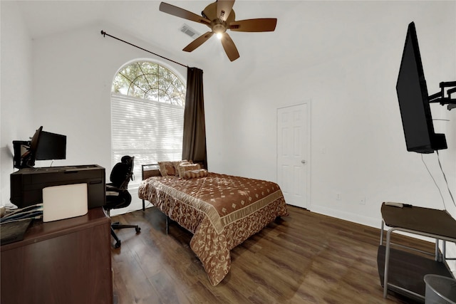 bedroom with vaulted ceiling, ceiling fan, and dark wood-type flooring