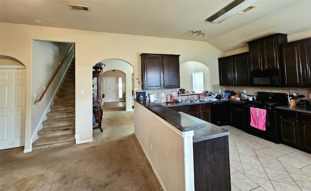 kitchen featuring kitchen peninsula, backsplash, sink, black appliances, and light tile patterned floors