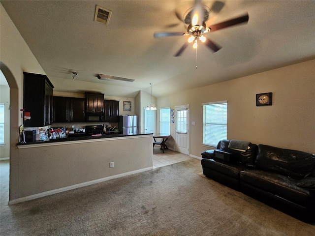 living room featuring light carpet, ceiling fan, and lofted ceiling