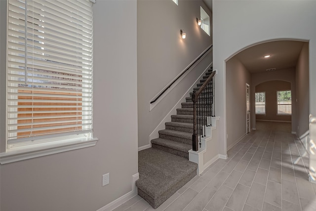 stairway with tile patterned flooring