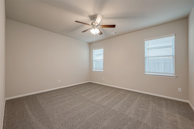 carpeted spare room with ceiling fan