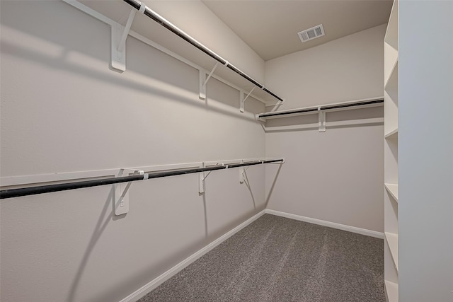 spacious closet featuring dark carpet