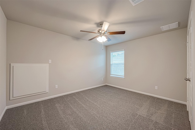 carpeted spare room featuring ceiling fan