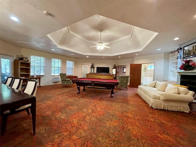 recreation room featuring ceiling fan, a textured ceiling, pool table, a tray ceiling, and carpet floors