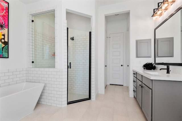 bathroom featuring tile patterned floors, vanity, and separate shower and tub