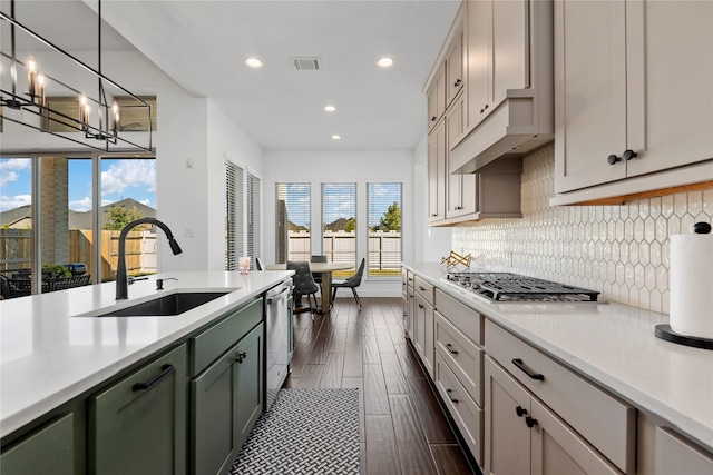 kitchen with decorative light fixtures, stainless steel appliances, a healthy amount of sunlight, and sink