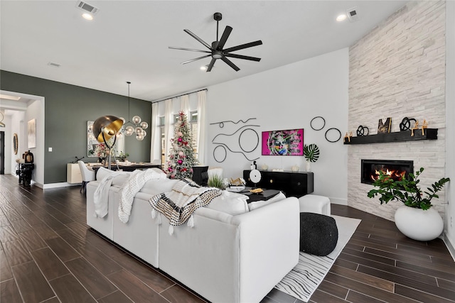 living room with ceiling fan and a fireplace