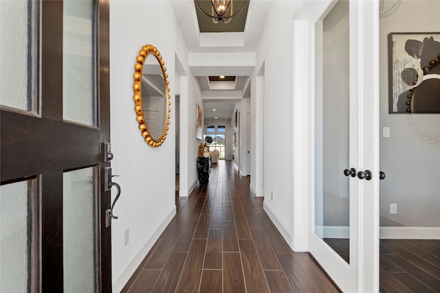 foyer entrance with a raised ceiling