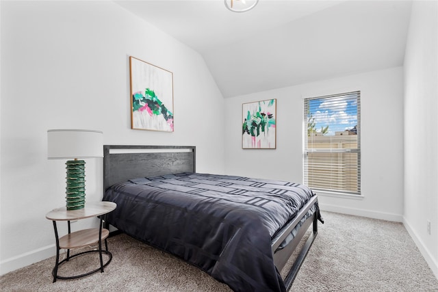 carpeted bedroom featuring lofted ceiling