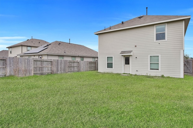 back of house featuring a yard