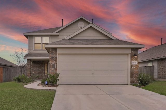 view of front of property featuring a garage and a yard