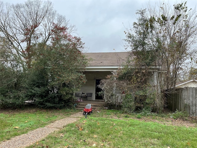 rear view of property with a lawn