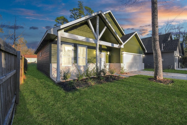 view of front of home with a lawn and a garage