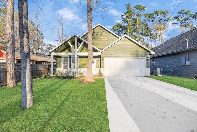 view of front of house with cooling unit, a front yard, and a garage