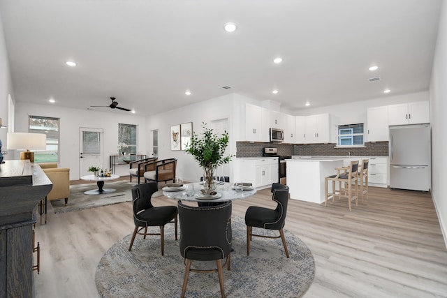 dining space featuring ceiling fan and light hardwood / wood-style floors