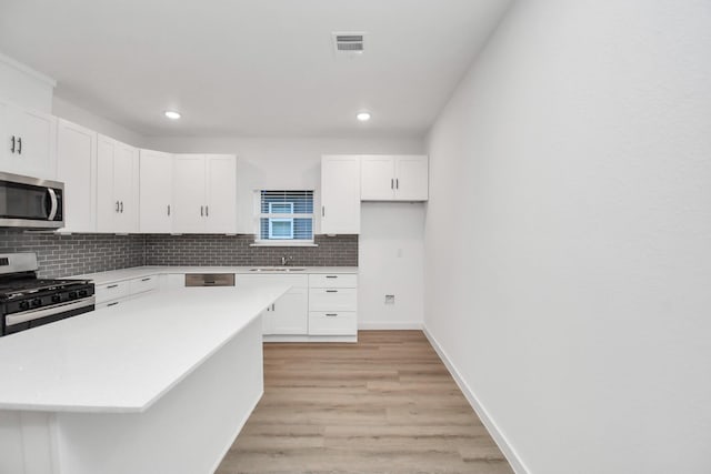 kitchen with a center island, white cabinets, and appliances with stainless steel finishes