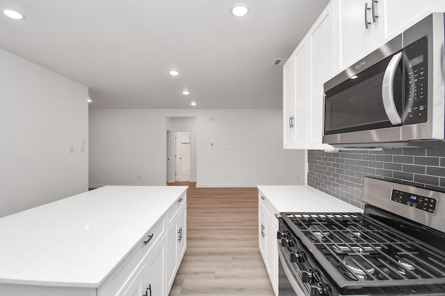 kitchen with a center island, white cabinets, and appliances with stainless steel finishes