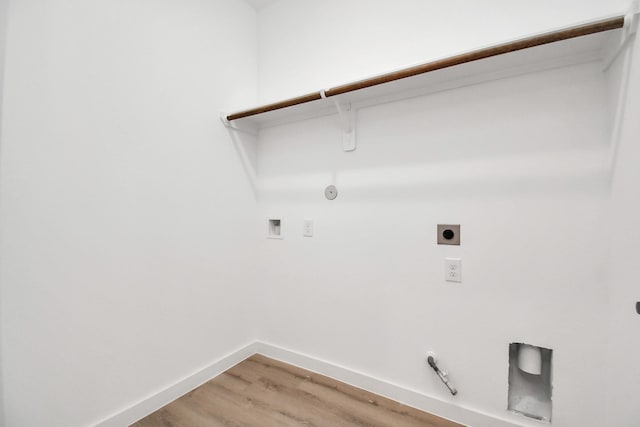 washroom featuring hardwood / wood-style flooring, electric dryer hookup, gas dryer hookup, and hookup for a washing machine