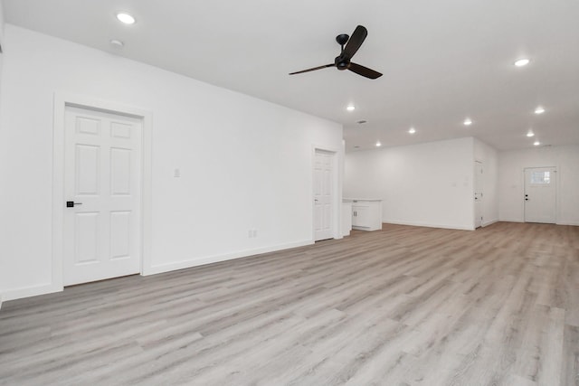 unfurnished living room with ceiling fan and light wood-type flooring