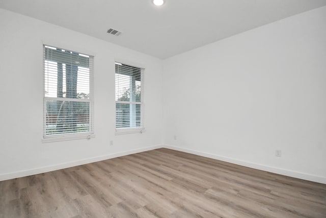 empty room with light hardwood / wood-style floors