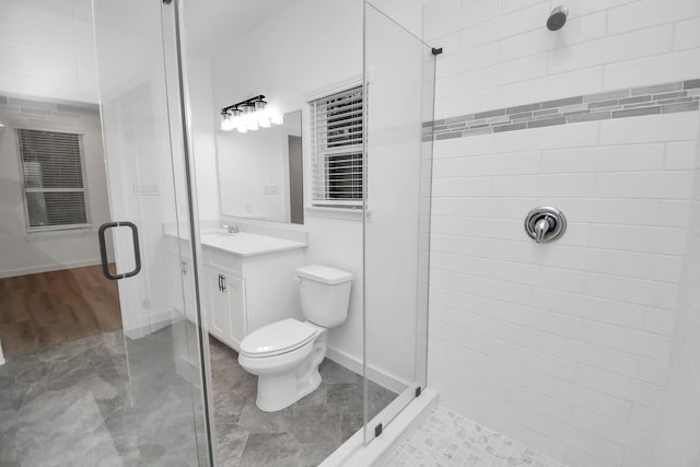 bathroom featuring vanity, toilet, and walk in shower