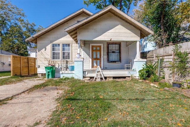 bungalow-style home with a front lawn and a porch