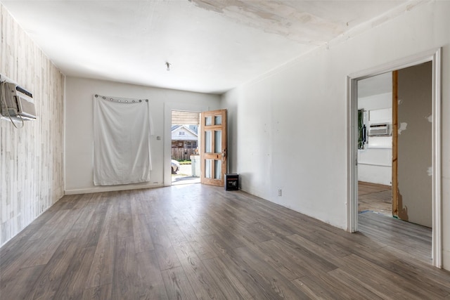 spare room with dark hardwood / wood-style flooring and a wall mounted air conditioner