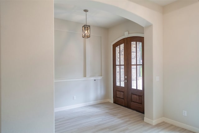 entrance foyer with french doors and light wood-type flooring