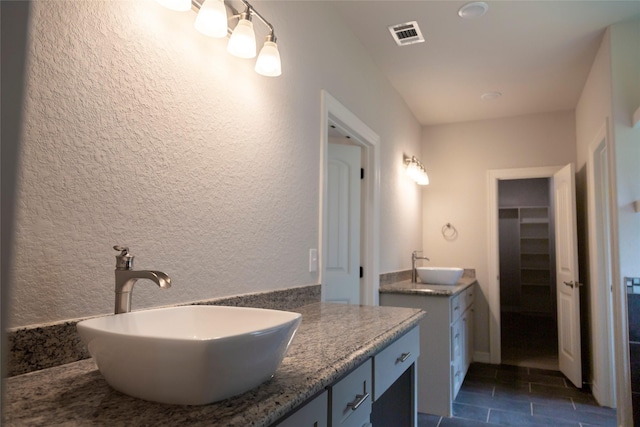 bathroom featuring tile patterned flooring and vanity