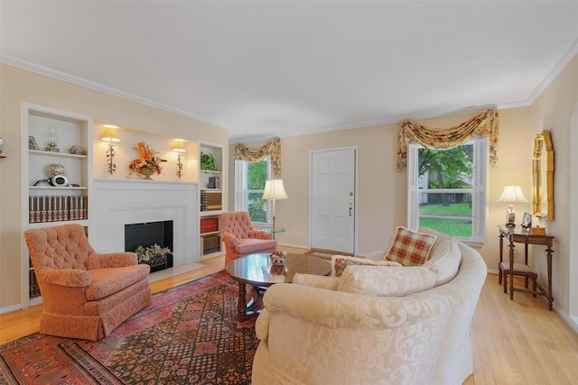 living room featuring crown molding, built in features, and light hardwood / wood-style flooring