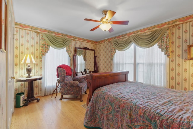 bedroom with ceiling fan and light hardwood / wood-style flooring