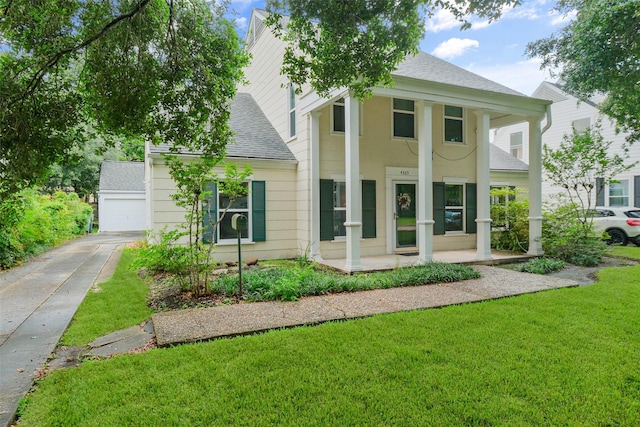 greek revival house featuring a front yard and roof with shingles