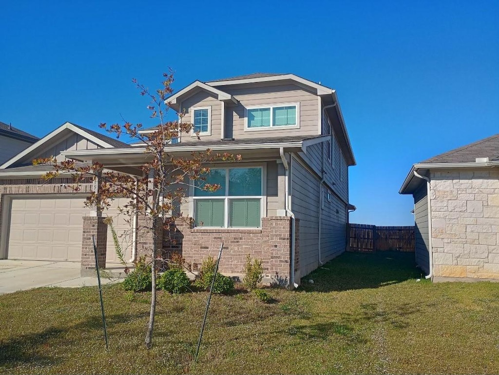 view of front of home with a garage and a front lawn