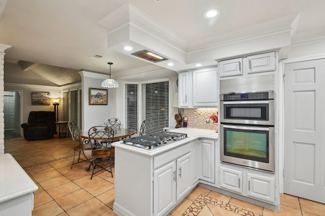 kitchen with white cabinets, kitchen peninsula, stainless steel appliances, and tasteful backsplash