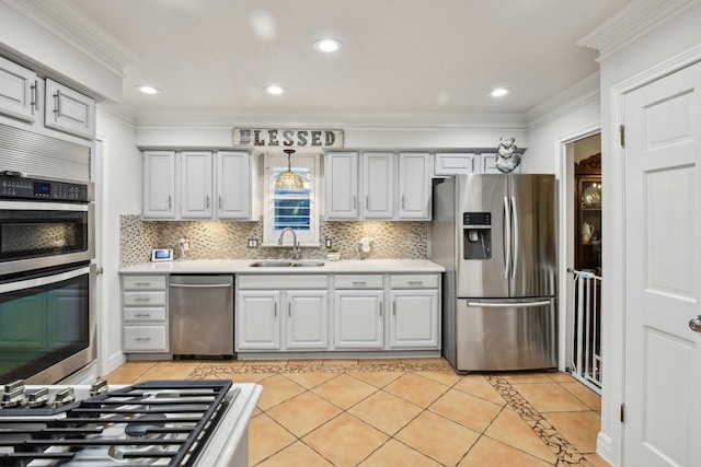 kitchen with sink, crown molding, decorative backsplash, light tile patterned flooring, and appliances with stainless steel finishes