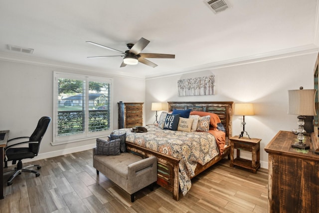 bedroom featuring hardwood / wood-style flooring, ceiling fan, and ornamental molding