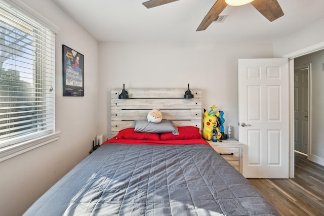 bedroom with ceiling fan and dark wood-type flooring