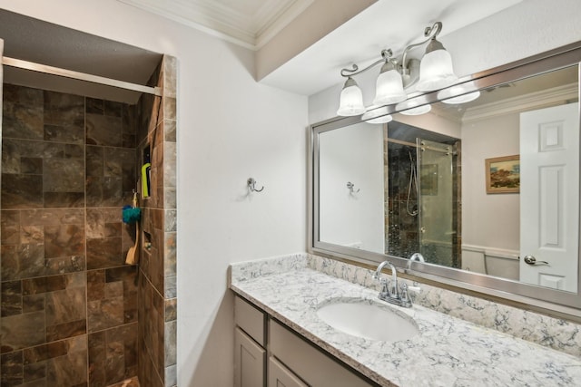 bathroom with vanity, an inviting chandelier, a shower with door, and ornamental molding