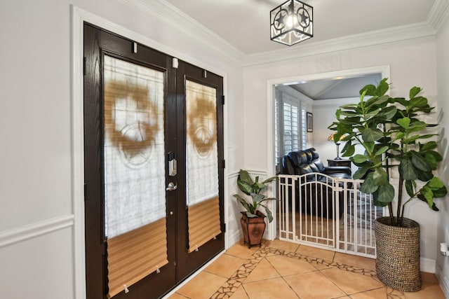 entrance foyer with french doors, light tile patterned floors, and ornamental molding