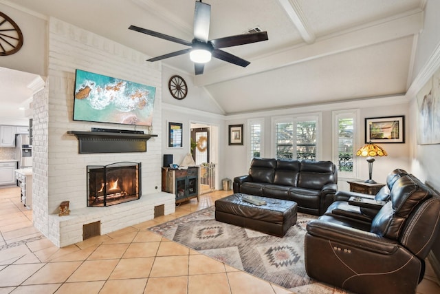 living room with vaulted ceiling with beams, ceiling fan, light tile patterned flooring, and a fireplace