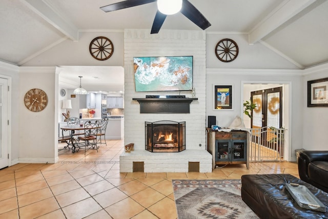 living room with crown molding, tile patterned flooring, vaulted ceiling with beams, ceiling fan, and a fireplace