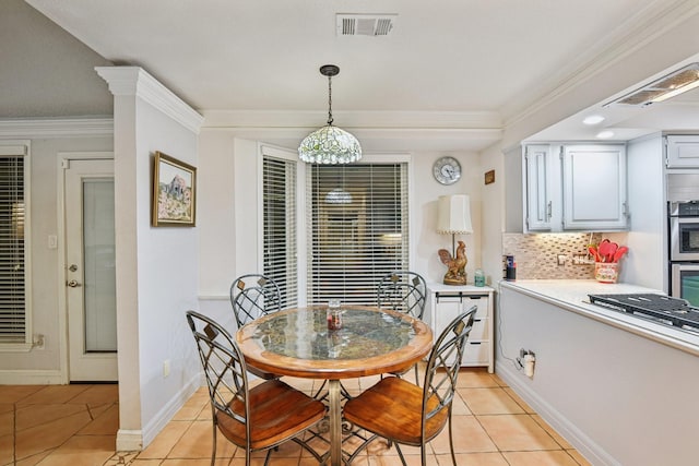 tiled dining area featuring ornamental molding