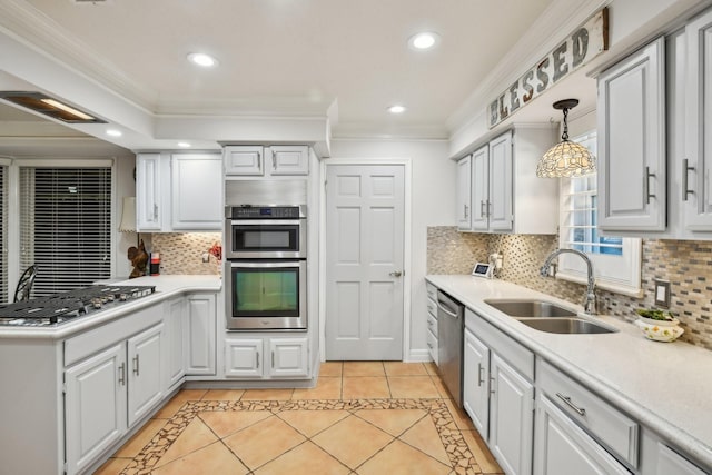 kitchen featuring stainless steel appliances, sink, white cabinets, hanging light fixtures, and light tile patterned flooring