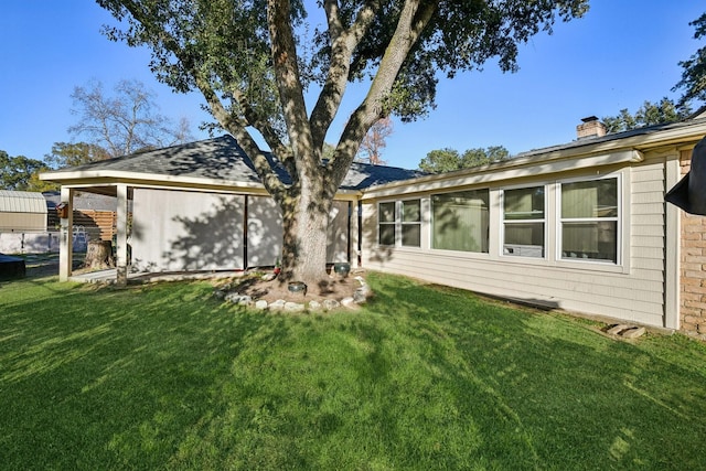 rear view of house with a yard