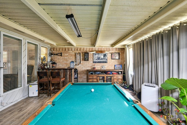 playroom with hardwood / wood-style floors, brick wall, billiards, and indoor bar