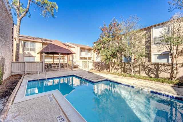 view of swimming pool featuring a gazebo and a patio area