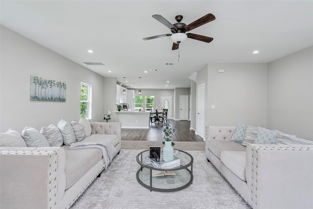 living room with hardwood / wood-style floors and ceiling fan