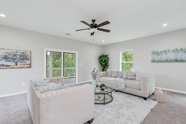 living room featuring carpet and ceiling fan