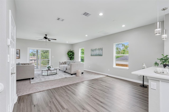 unfurnished living room with ceiling fan and hardwood / wood-style flooring